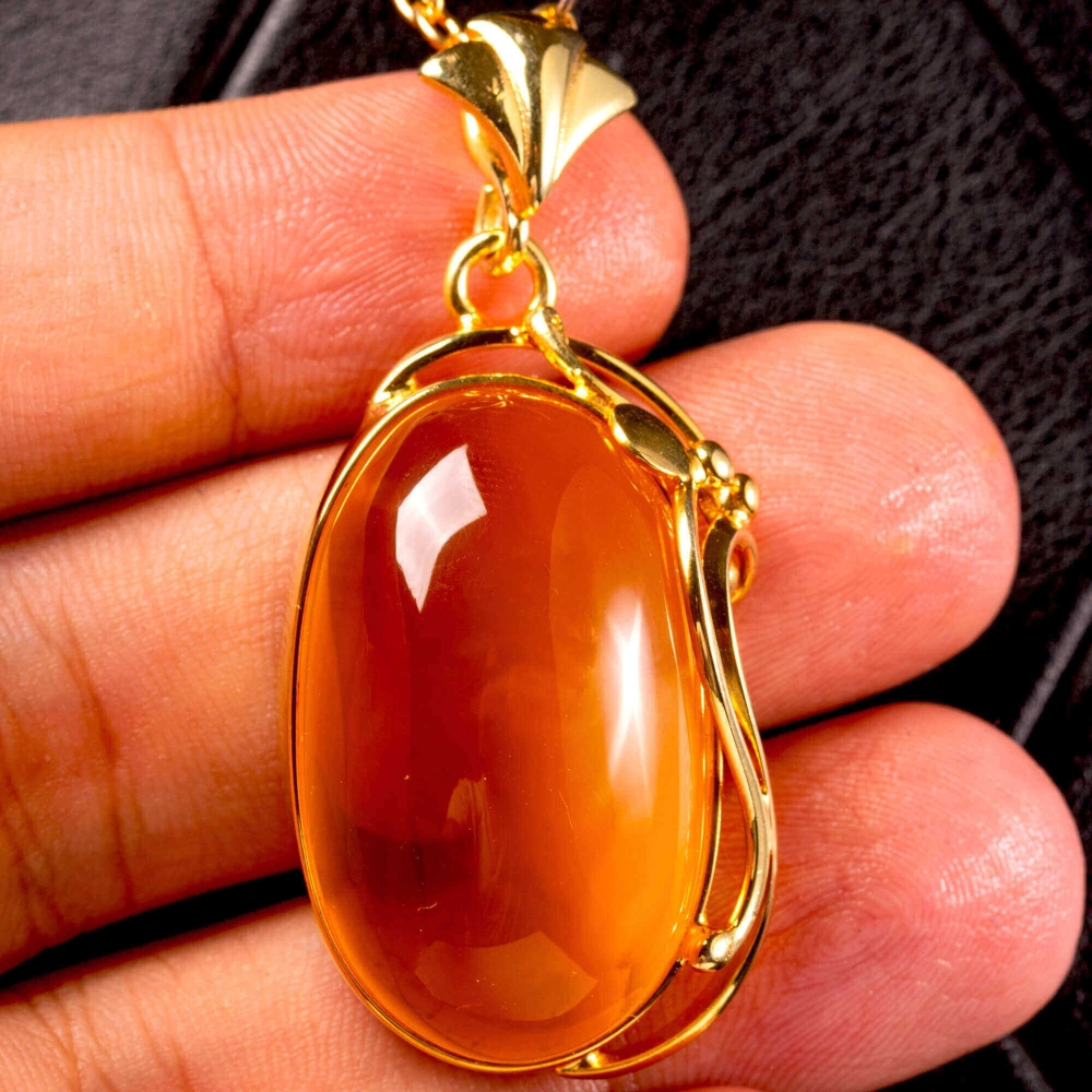 Baltic honey amber pendant: natural stone set in gilded silver