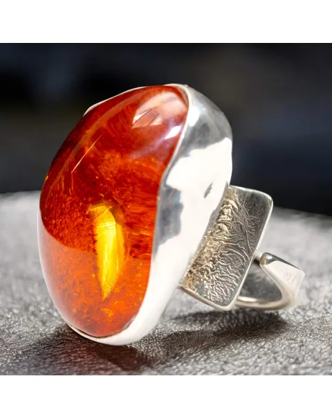 Anello in argento con ambra rossa e arancione: forza e protezione energetica.