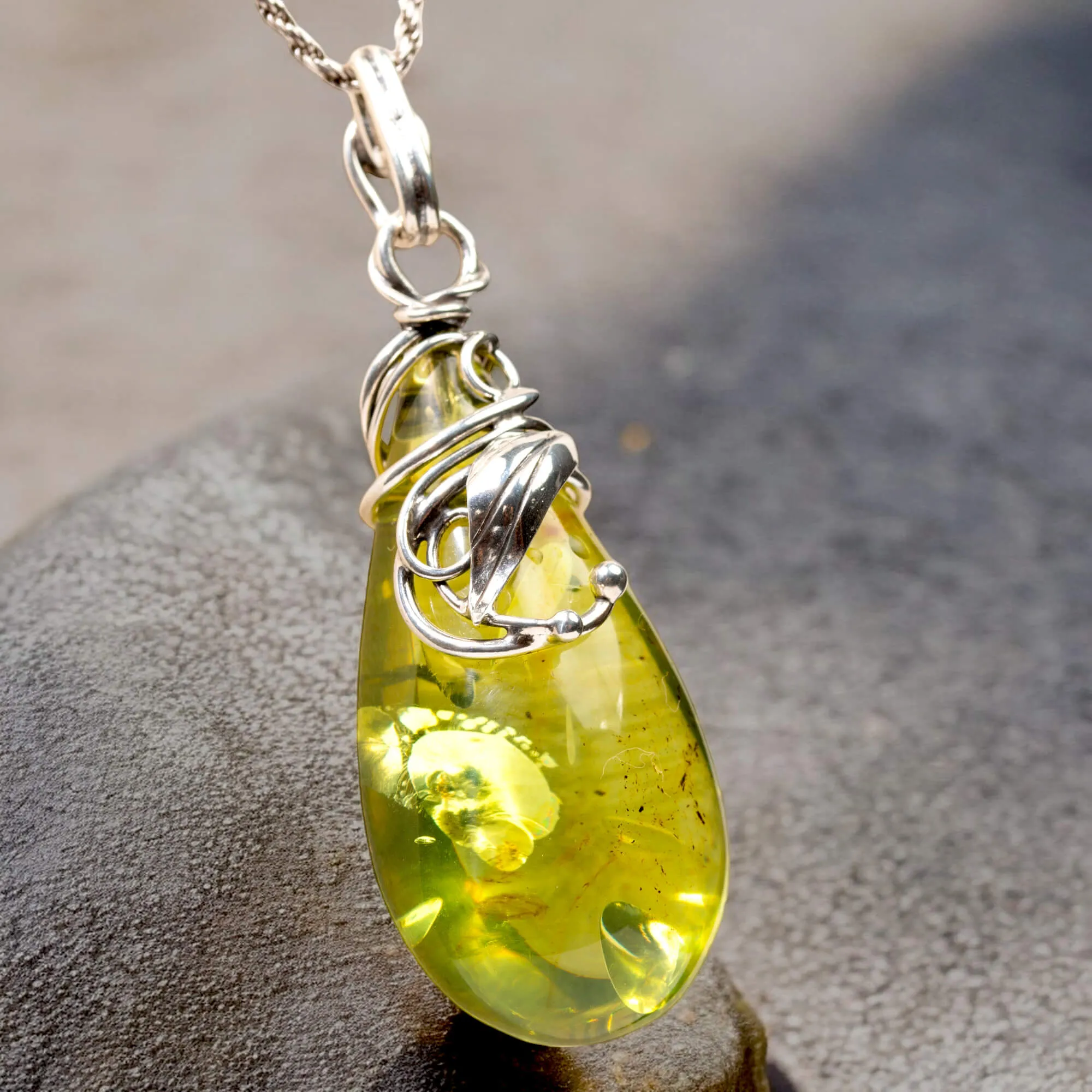 Ciondolo in argento con ambra verde: eleganza e armonia naturale.
