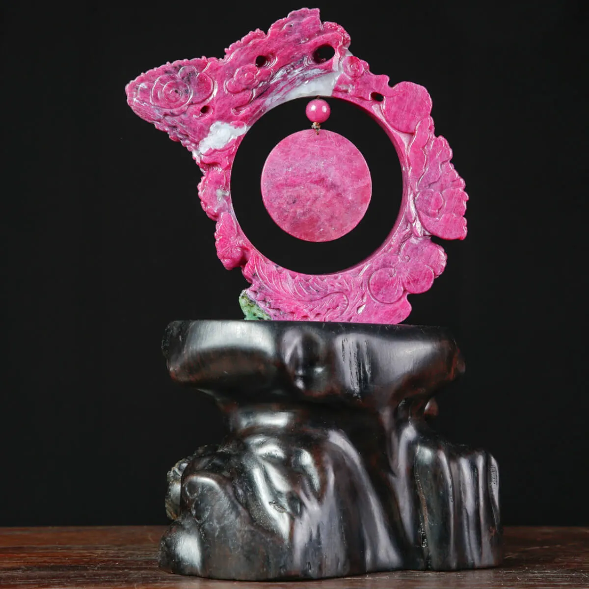 Magnifico intaglio in rubino su base in legno.